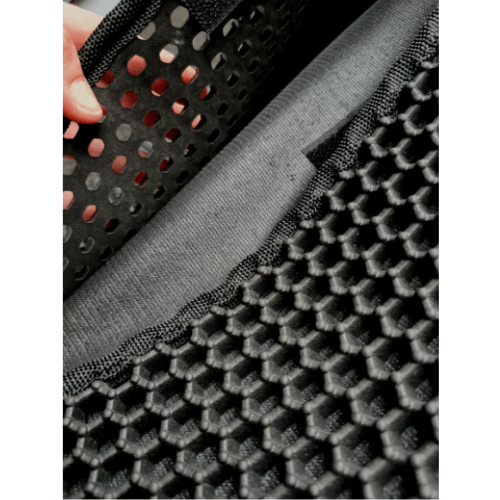 A close up of a person touching an Anythingpets-356 Litter Catch Mat.